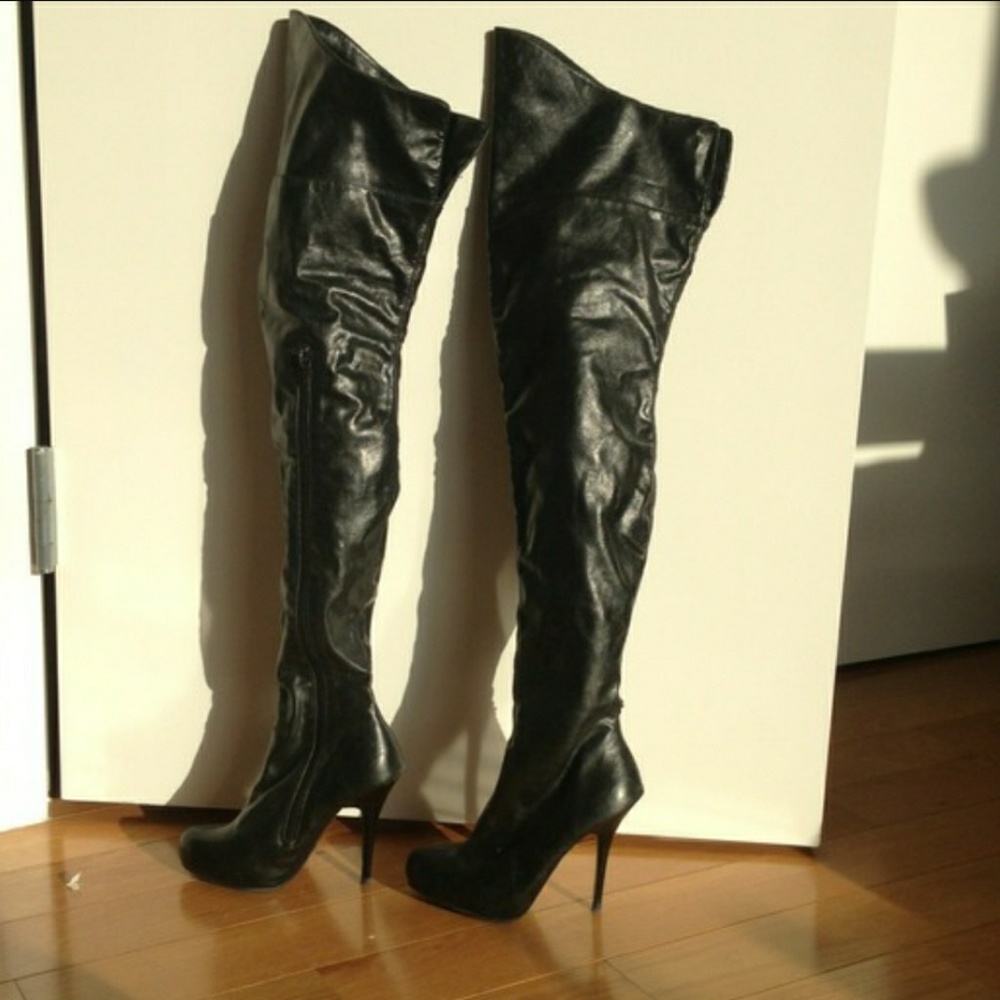 Black mid-thigh, over the knee leather boots.